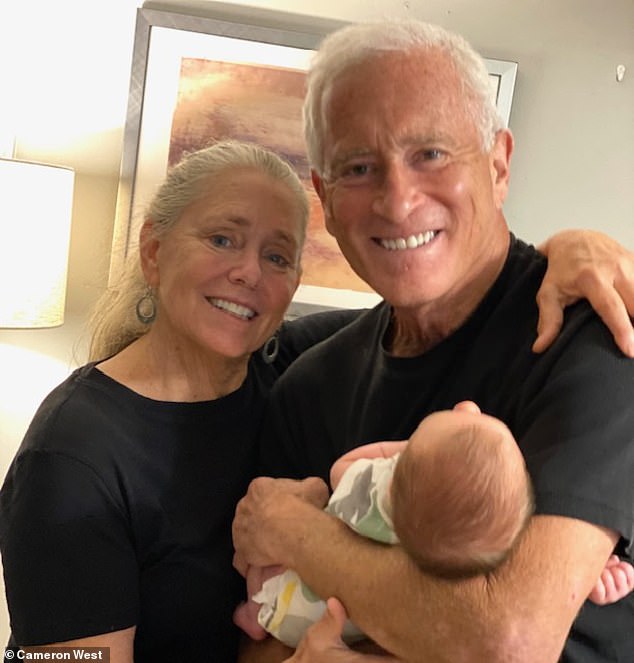 Cameron and Rikki West with their grandchild